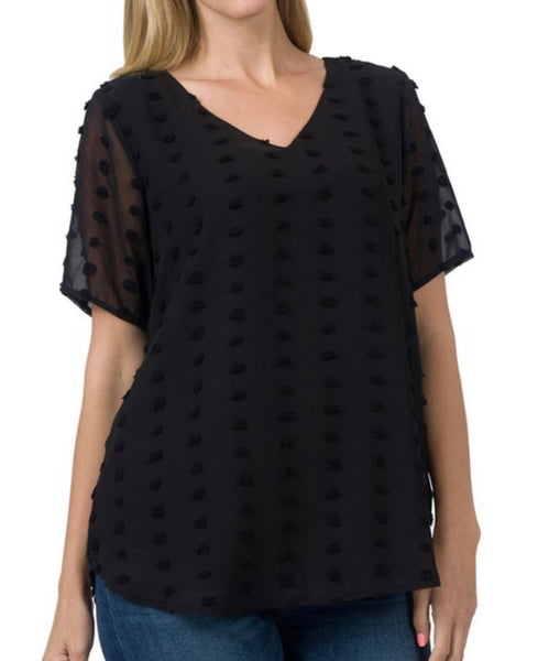 Model wearing our black swiss dot top! The top is short sleeve and neck. The sleeves are sheer but the rest of the top is not.  