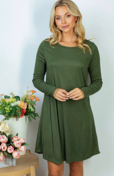 Model wearing our olive ribbed dress. The dress is long sleeve and hits just above the knee.